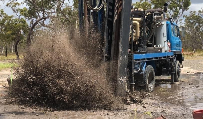 Blue truck driving on mud — Bore Drilling in Sunshine Coast, QLD