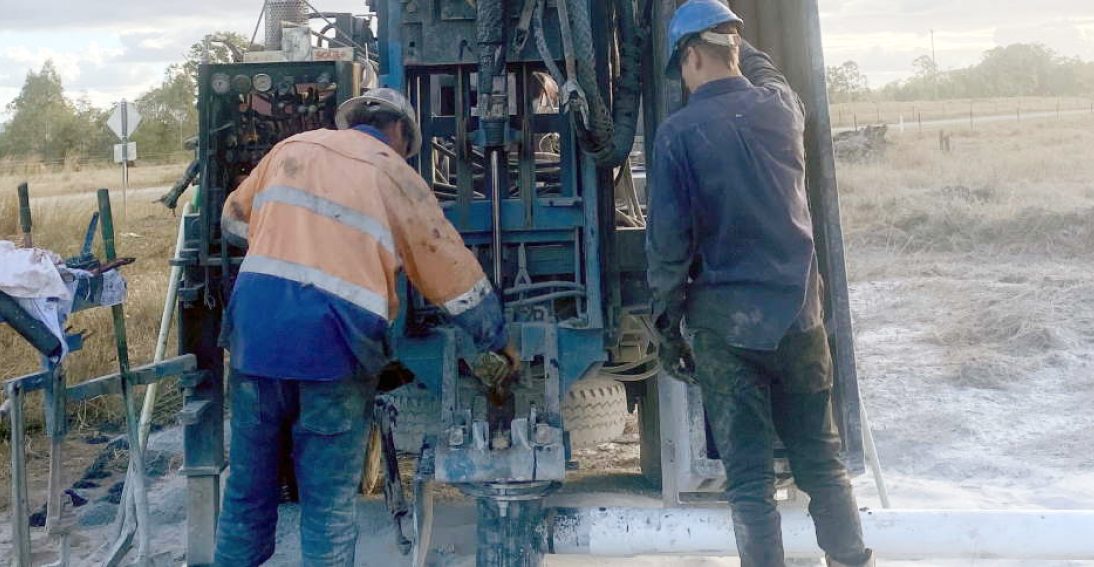 2 workers working on boring machine — Bore Drilling in Bundaberg, QLD